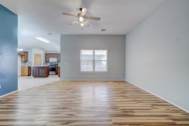 unfurnished living room featuring light hardwood / wood-style floors, vaulted ceiling, and ceiling fan