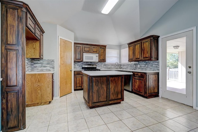 kitchen with backsplash, black range oven, vaulted ceiling, dishwasher, and a center island