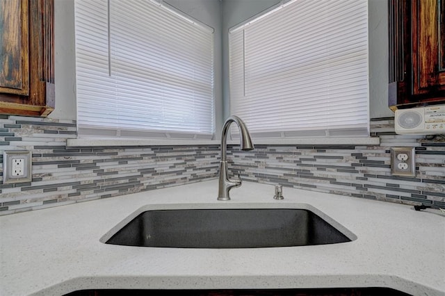 kitchen featuring tasteful backsplash and sink