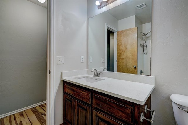 bathroom featuring hardwood / wood-style floors, vanity, and toilet