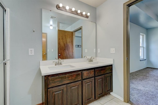 bathroom featuring tile patterned flooring and vanity