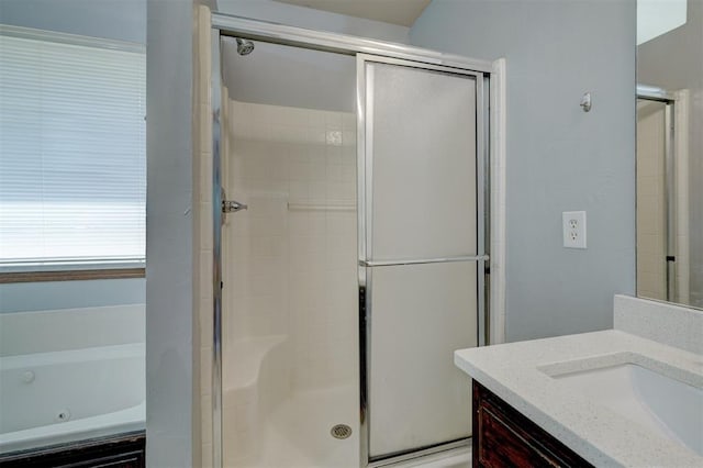 bathroom featuring vanity and separate shower and tub