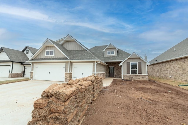 craftsman house featuring driveway, roof with shingles, board and batten siding, a garage, and brick siding