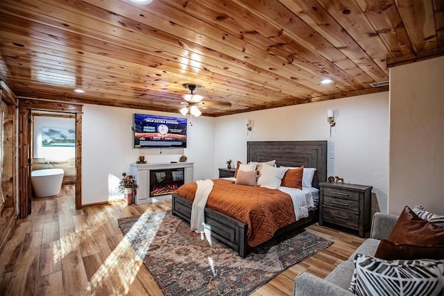 bedroom with light hardwood / wood-style floors, ceiling fan, wooden ceiling, and ensuite bathroom