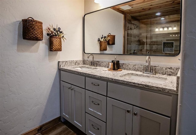 bathroom with hardwood / wood-style floors, vanity, wooden ceiling, and walk in shower