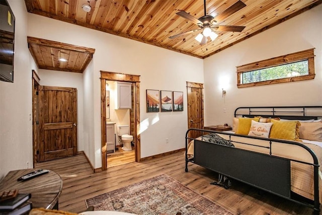 bedroom with wooden ceiling, lofted ceiling, ceiling fan, connected bathroom, and light hardwood / wood-style floors