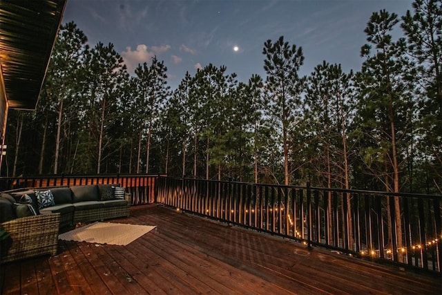 deck at dusk with an outdoor hangout area