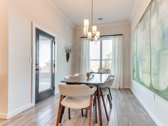 dining room with an inviting chandelier and crown molding