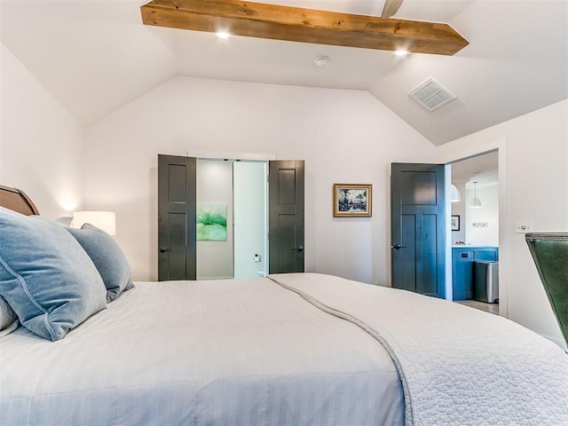 bedroom with vaulted ceiling with beams