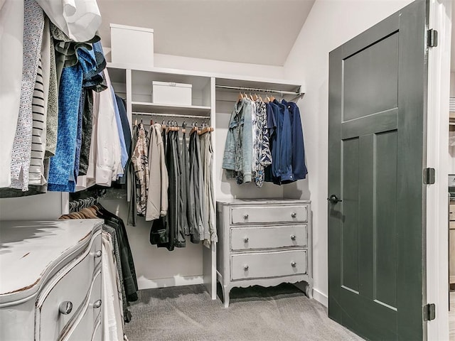 spacious closet featuring vaulted ceiling and carpet