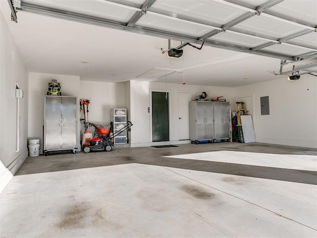 garage with a garage door opener and electric panel