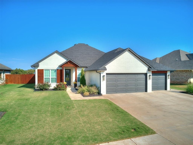 view of front of house featuring a garage and a front lawn