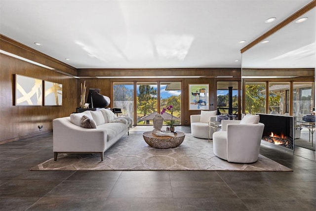 living room with a healthy amount of sunlight, french doors, and wooden walls