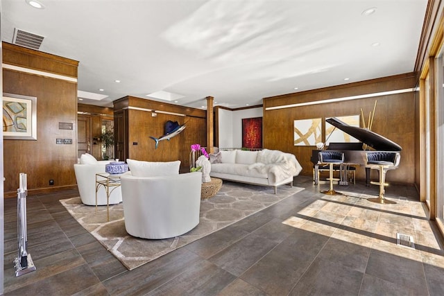 living room with wooden walls and ornamental molding