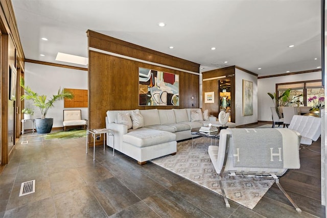 living room featuring crown molding and wood walls