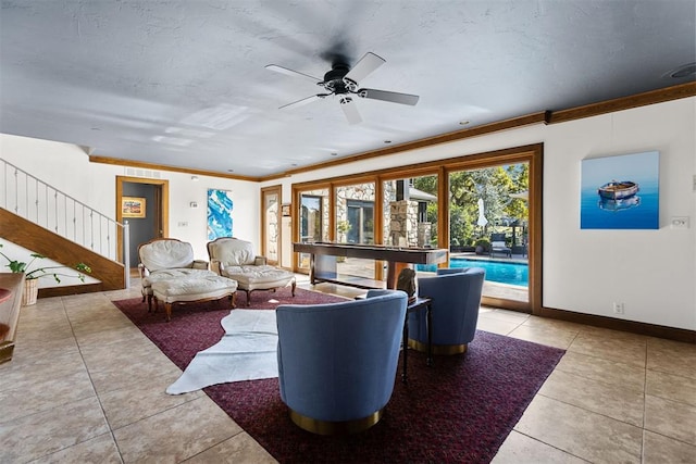 living room featuring ceiling fan, light tile patterned flooring, and crown molding