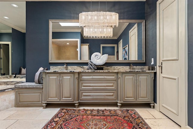 bathroom with a chandelier, vanity, and crown molding