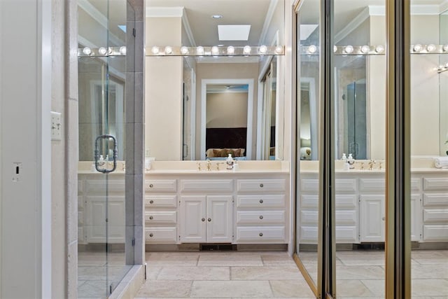 bathroom featuring vanity, a shower with shower door, and ornamental molding