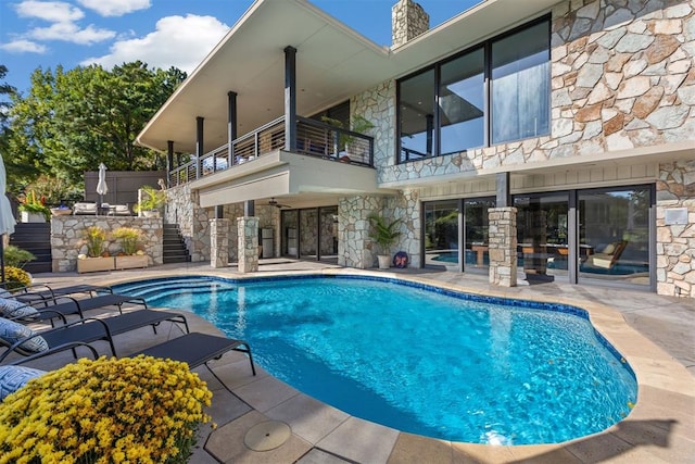 view of swimming pool featuring a patio area