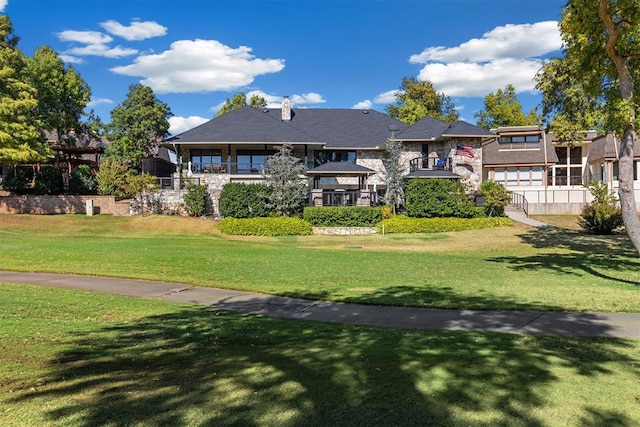 rear view of house featuring a yard