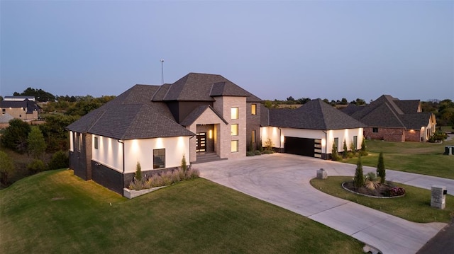 view of front of property with a lawn and a garage