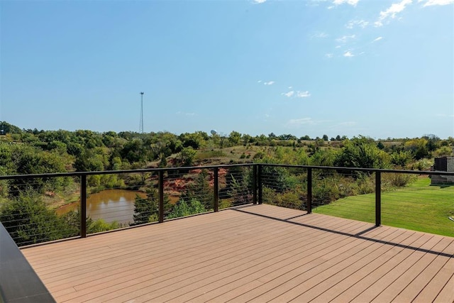 deck with a yard and a water view