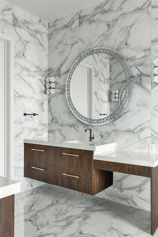 bathroom with vanity and tile walls