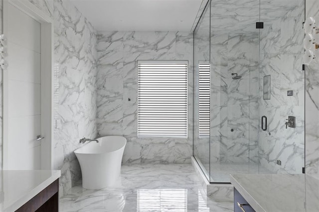 bathroom featuring plus walk in shower, vanity, and tile walls