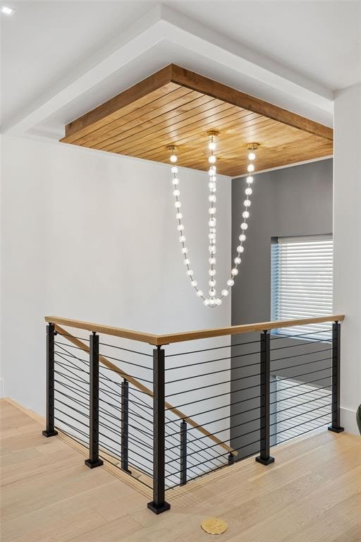 corridor featuring wood-type flooring and wooden ceiling