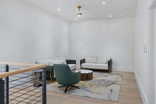 sitting room featuring ceiling fan and light hardwood / wood-style floors