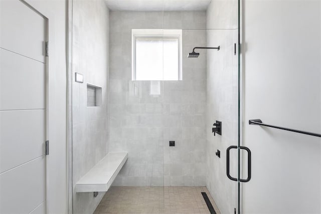 bathroom with a shower with door