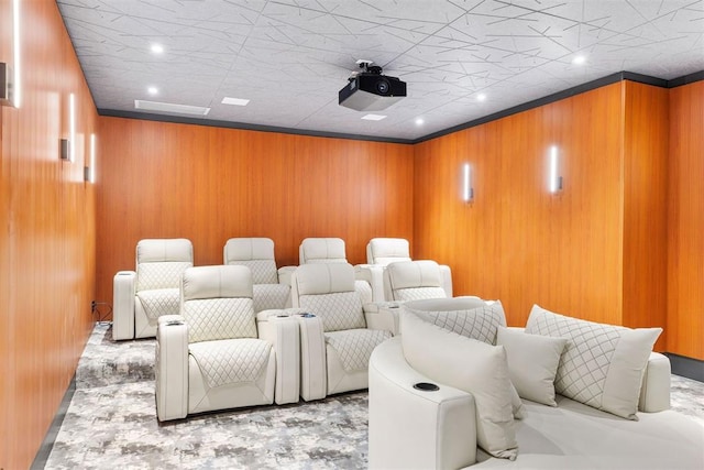 home theater with wood walls and ornamental molding