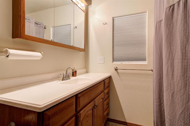 bathroom featuring vanity and curtained shower