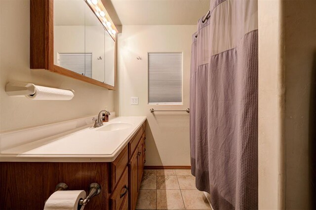 bathroom featuring tile patterned flooring and vanity