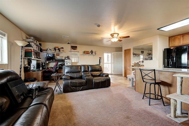 living room with ceiling fan and light colored carpet