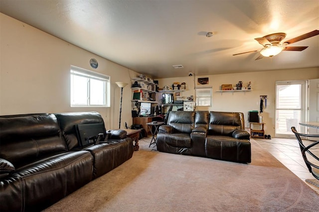 tiled living room featuring ceiling fan