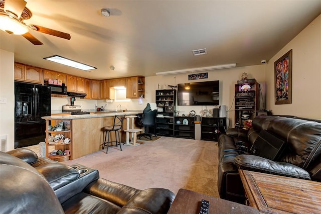 living room featuring ceiling fan and light colored carpet