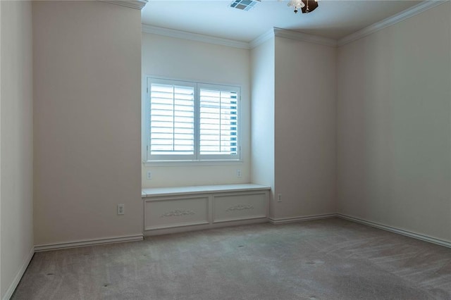 spare room with baseboards, ornamental molding, visible vents, and light colored carpet