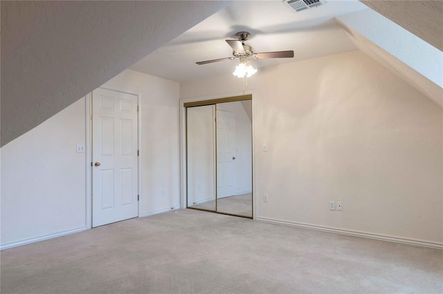 additional living space featuring a skylight, light colored carpet, visible vents, a ceiling fan, and baseboards