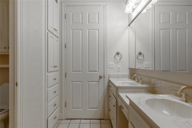 bathroom with double vanity, tile patterned flooring, and a sink