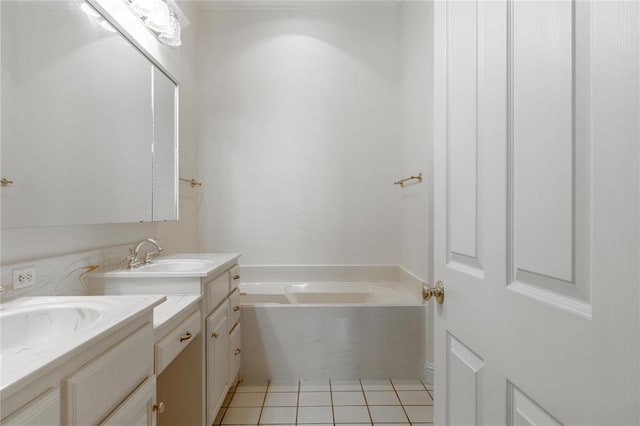 full bath featuring a tub, vanity, and tile patterned floors