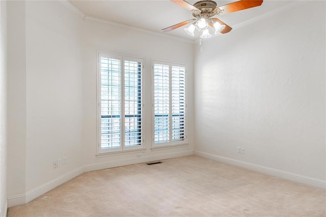 empty room with a wealth of natural light, light carpet, and crown molding