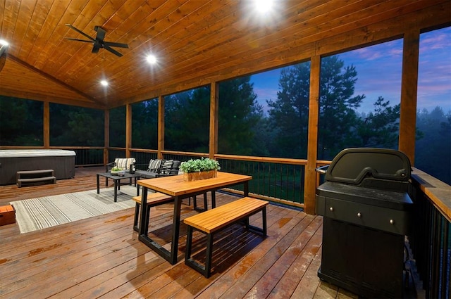 sunroom featuring lofted ceiling, ceiling fan, and wooden ceiling