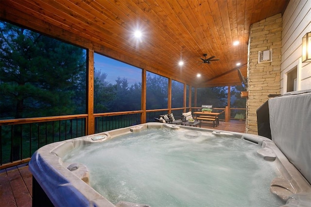 sunroom / solarium featuring vaulted ceiling, a hot tub, ceiling fan, and wood ceiling