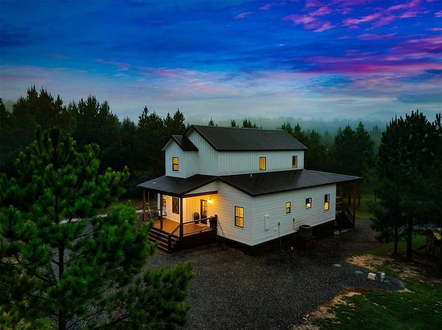 back house at dusk featuring cooling unit