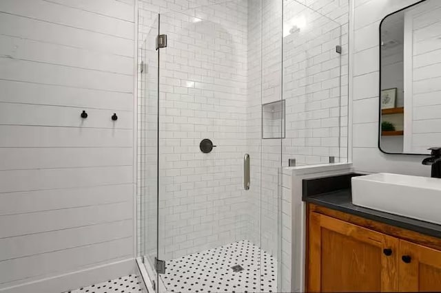 bathroom featuring vanity and an enclosed shower