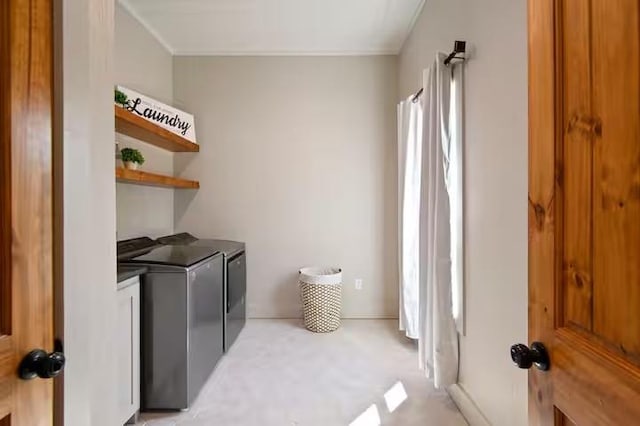 clothes washing area with washer and clothes dryer