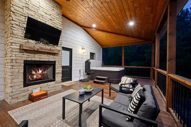 interior space featuring lofted ceiling, wooden ceiling, and an outdoor stone fireplace