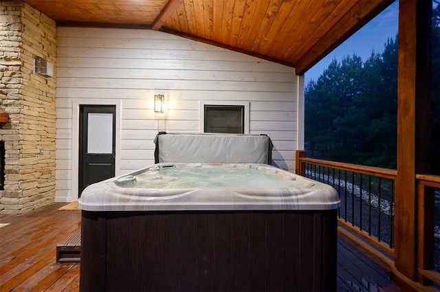 wooden deck featuring a hot tub