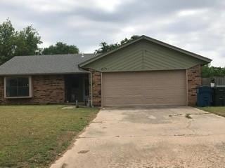 ranch-style house with a front yard and a garage